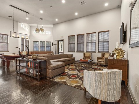 a living room with couches and chairs and a rug